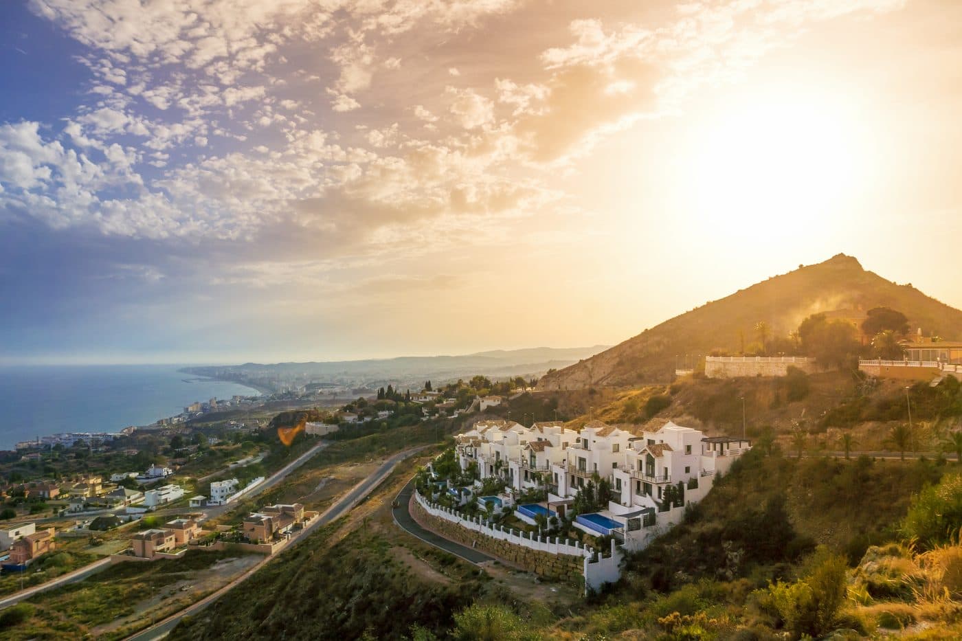 Narrow white lanes in the mountain village of Benahavís with restaurants and flower boxes