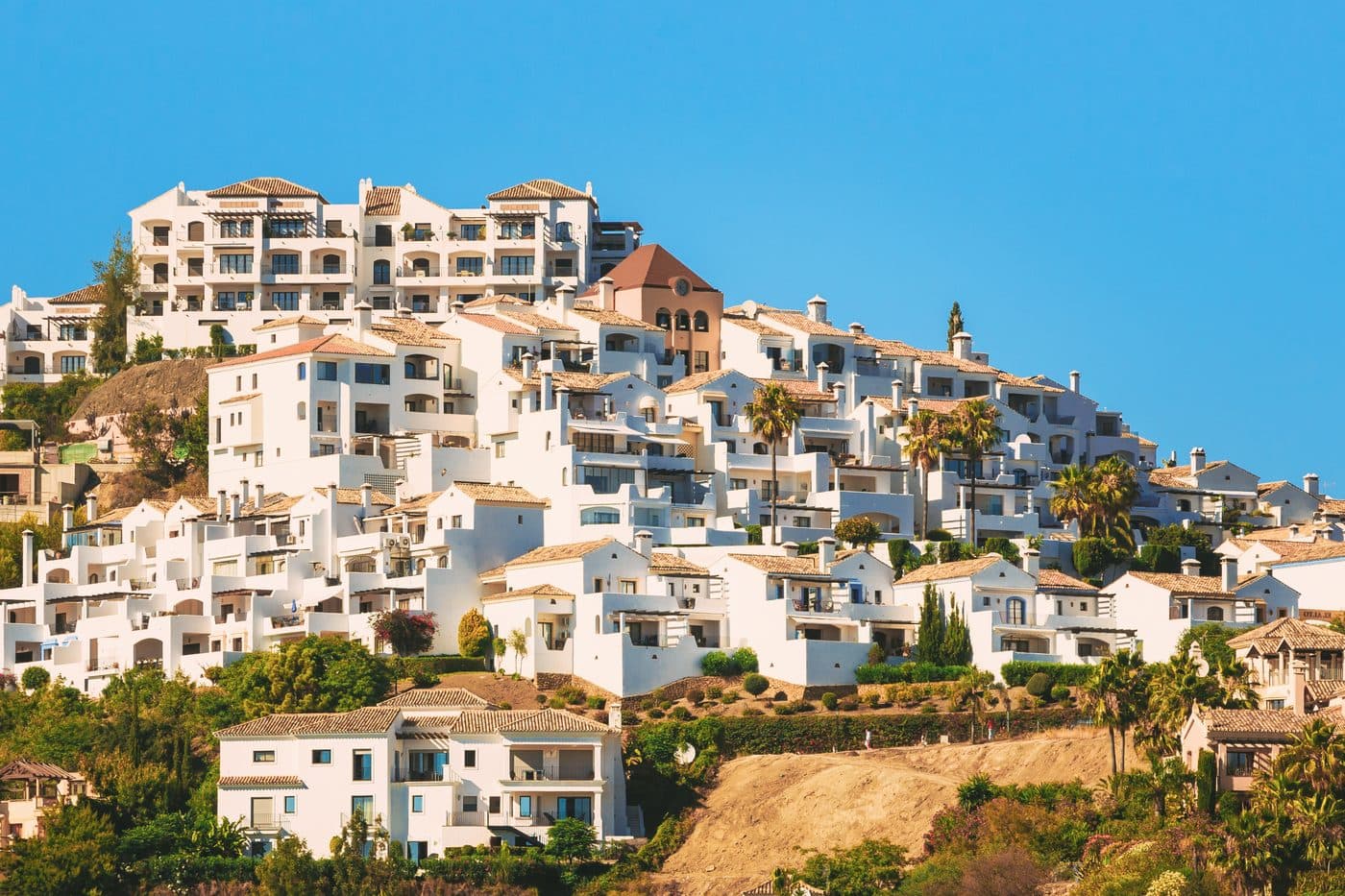 View over the white mountain village of Benahavís with the surrounding mountains and villa estates
