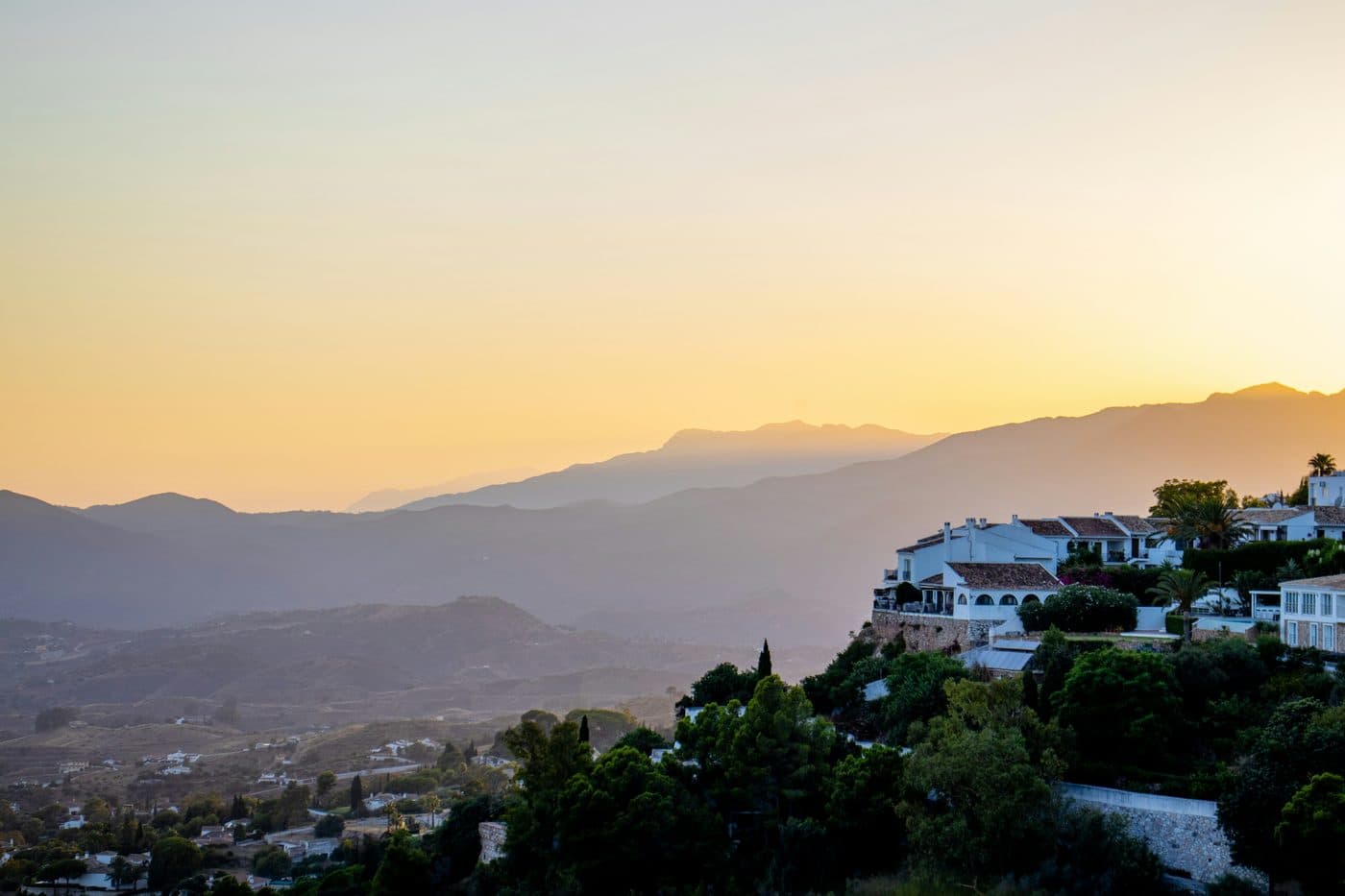 White houses and steep lanes in Mijas Pueblo with sea views